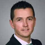 jüngerer dunkelhaariger Mann mit weißem Hemd