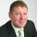 Blonder Mann mit grüner Krawatte