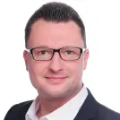 lächelnder Mann im Anzug mit Brille