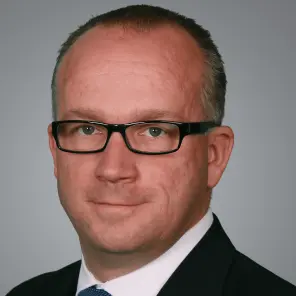 Mann mit Brille und blauer Krawatte