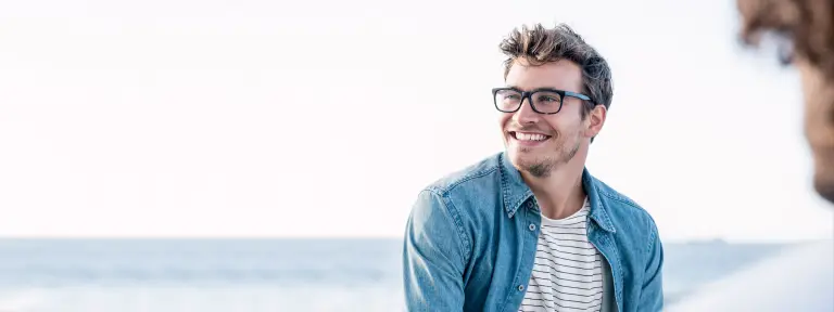 Junger Mann mit Brille lacht