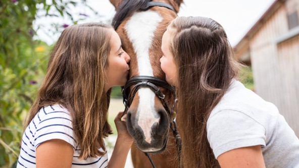 Zwei Mädchen mit ihrem Pferd